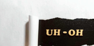 Torn paper revealing UH-OH text underneath.