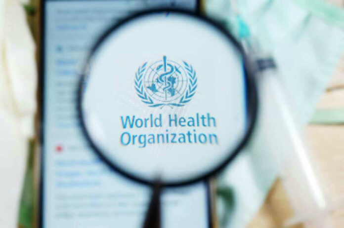 1730307721 Magnifying glass focused on World Health Organization logo.