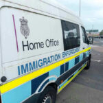 Shocking LEGISLATION Proposal: 10-Year Immigration Freeze White immigration enforcement van parked by roadside