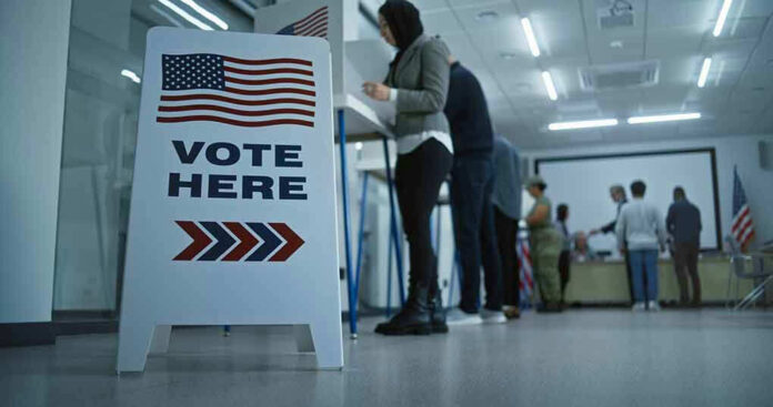 Sign reading Vote Here in a polling station.