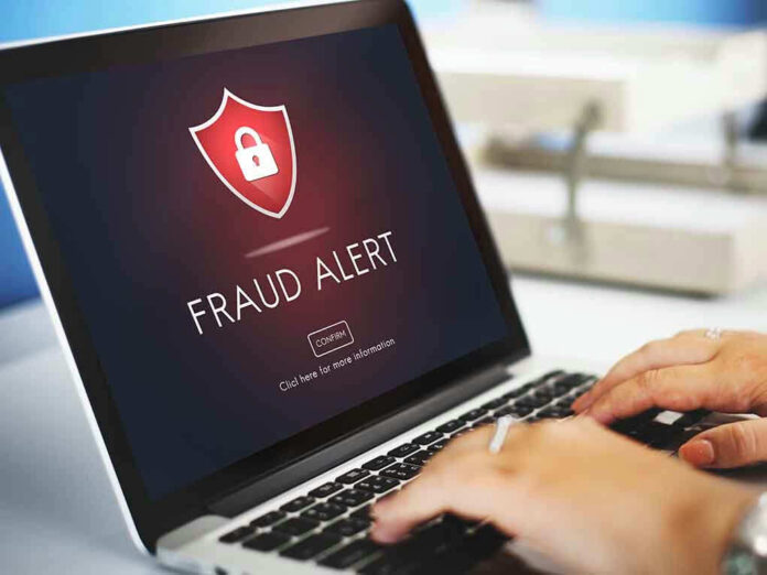 Laptop displaying fraud alert warning on screen