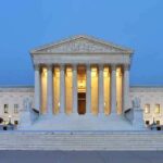 The U.S. Supreme Court building illuminated at night