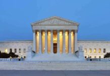 The U.S. Supreme Court building illuminated at night