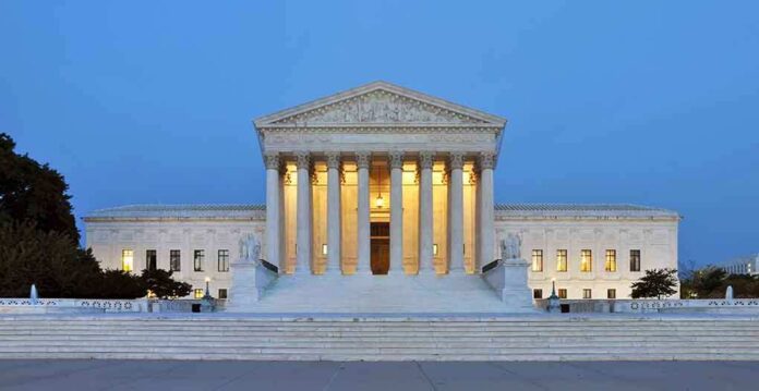 The U.S. Supreme Court building illuminated at night