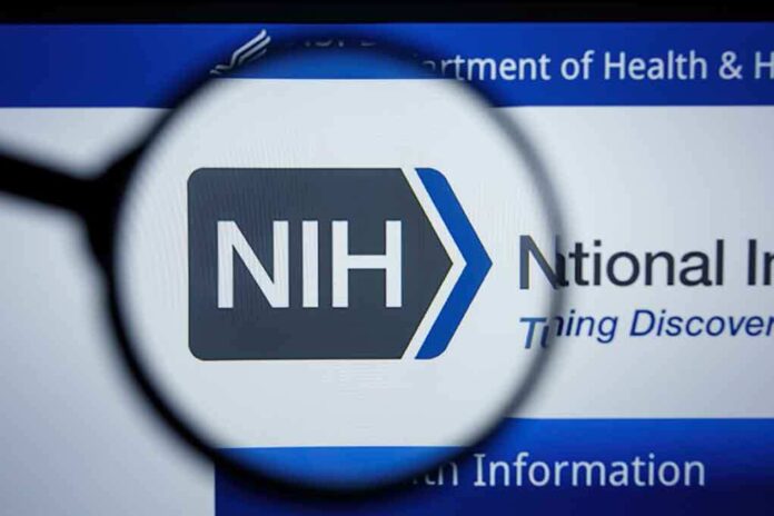 NIH logo viewed through a magnifying glass on a digital screen