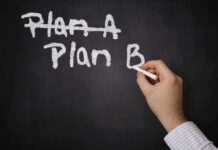 A hand writing Plan B on a chalkboard with Plan A crossed out