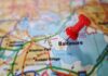 A red pushpin marking the location of Baltimore on a map