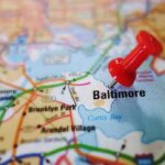 A red pushpin marking the location of Baltimore on a map