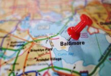 A red pushpin marking the location of Baltimore on a map