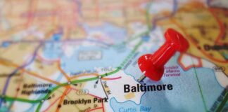 A red pushpin marking the location of Baltimore on a map
