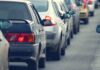 A line of cars stuck in traffic on a roadway