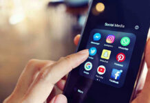 Finger tapping smartphone social media app icons.