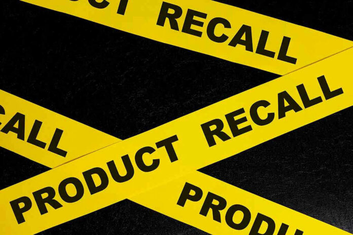 Yellow tape with product recall text on black background.