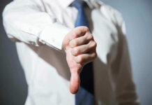 Person giving a thumbs down gesture.