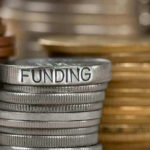 Retiree Benefits Seized While Wall Street Profits SOAR Stack of coins labeled funding with other coins stacks