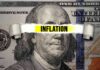 A torn paper strip with the word 'INFLATION' over a hundred dollar bill featuring Benjamin Franklin