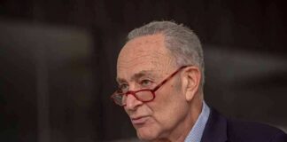 A man with glasses speaking passionately during a public address