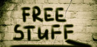 Graffiti on a brick wall stating FREE STUFF with an arrow