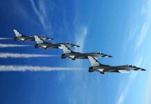 F-35 INSTRUCTOR ARRESTED — Shocking Treachery Four military jets flying in formation against a blue sky, leaving smoke trails