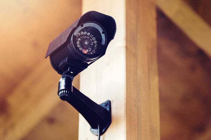 shutterstock_769627117 (1).jpg A security camera mounted on a wooden wall