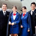 Group of airline crew members posing together at an airport