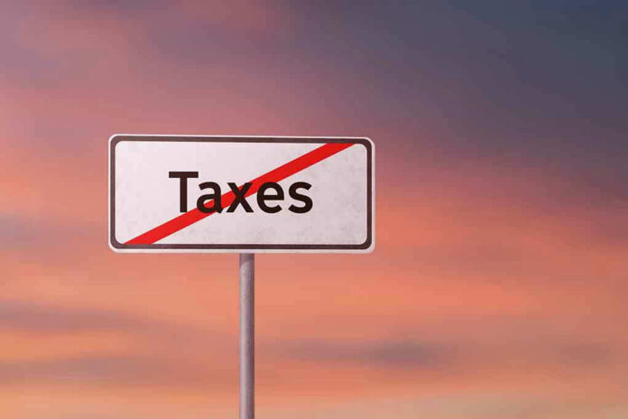 Sign with the word Taxes crossed out.