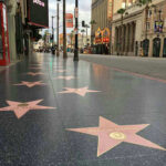 Hollywood Walk of Fame stars on sidewalk.