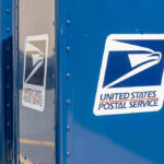 USPS Desperate PLEA to Congress Blue USPS mail collection boxes in a row.