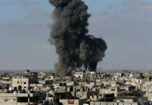 Large explosion over a crowded urban area.