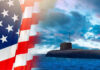 Submarine Nightmare: NAVY’S Hidden Weakness American flag and submarine at sea under a cloudy sky.