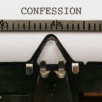 Typewriter with CONFESSION on paper.