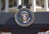 Close-up of the presidential seal on a podium