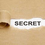 $5,000 Twist Reopens Epstein Death Mystery A torn piece of brown paper revealing the word SECRET underneath
