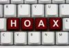 Close-up of a computer keyboard with the word HOAX spelled out in red keys