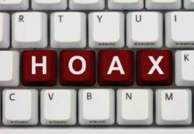 Close-up of a computer keyboard with the word HOAX spelled out in red keys