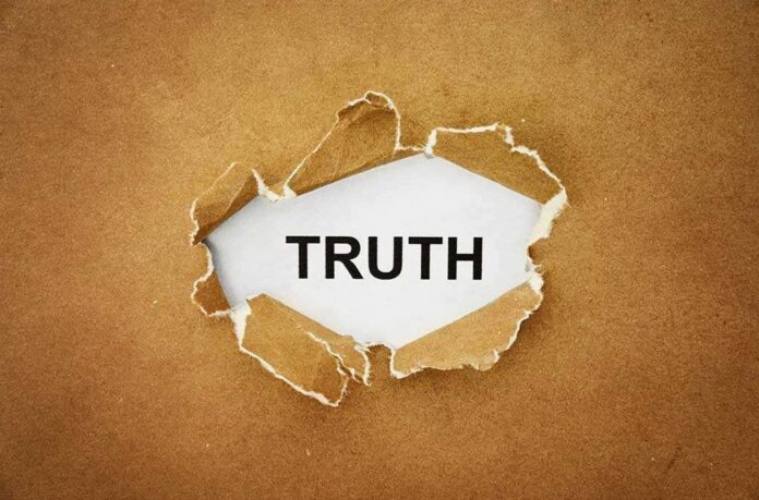 shutterstock_211611715.jpg A piece of torn paper revealing the word TRUTH underneath