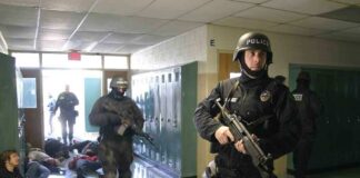 Police officers responding to a school emergency with students on the floor