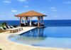 A luxurious poolside gazebo overlooking the ocean with sun loungers