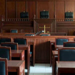 Judge’s Bold Move: Kirk Murder Trial Goes Public Empty courtroom with wooden furnishings and judges bench.