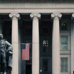 Giuliani’s Coma Miracle: True Story or Illusion? US Treasury Department building with statue and flag.