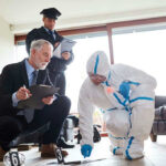 Forensic team examining evidence at a crime scene indoors.