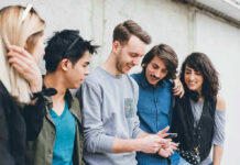 Group of friends looking at a smartphone.