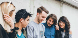 Group of friends looking at a smartphone.