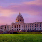 Supreme Court’s Voting Shift Sparks Redraw Chaos Historic building with dome under a pinkish-purple sky.