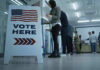 Trump Topples Rebel Congressman – He’s OUT! Sign reading Vote Here in a polling station.