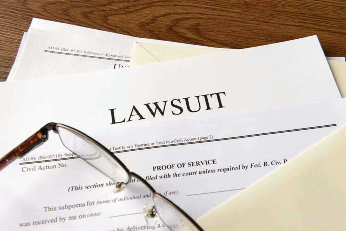 Documents labeled Lawsuit with glasses on top.