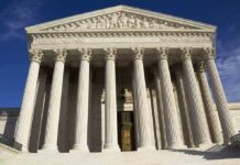 Facade of the Supreme Court building featuring tall columns and intricate carvings