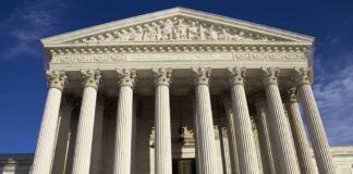 Facade of the Supreme Court building featuring tall columns and intricate carvings