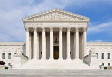 Swatting Madness Strikes Justice’s Home Front view of the Supreme Court building with large columns and steps under a blue sky