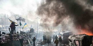 A chaotic protest scene with smoke, fire, and people holding flags